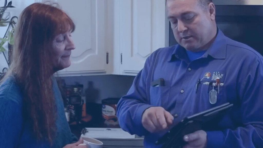 man and women standing in kitchen looking at prices on a clipboard