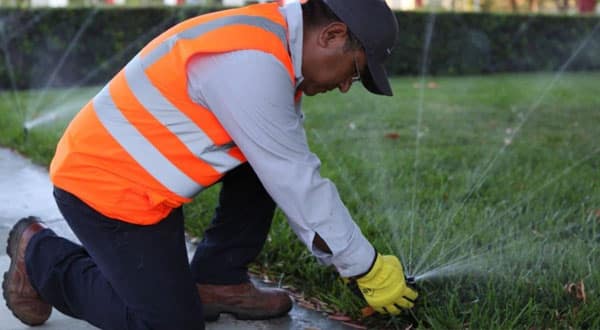 Man installing lawn sprinklers